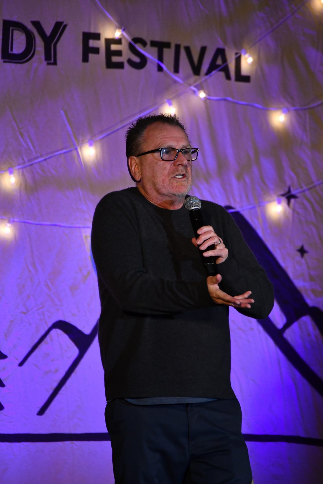 Headliner mid-punchline under the festival lights