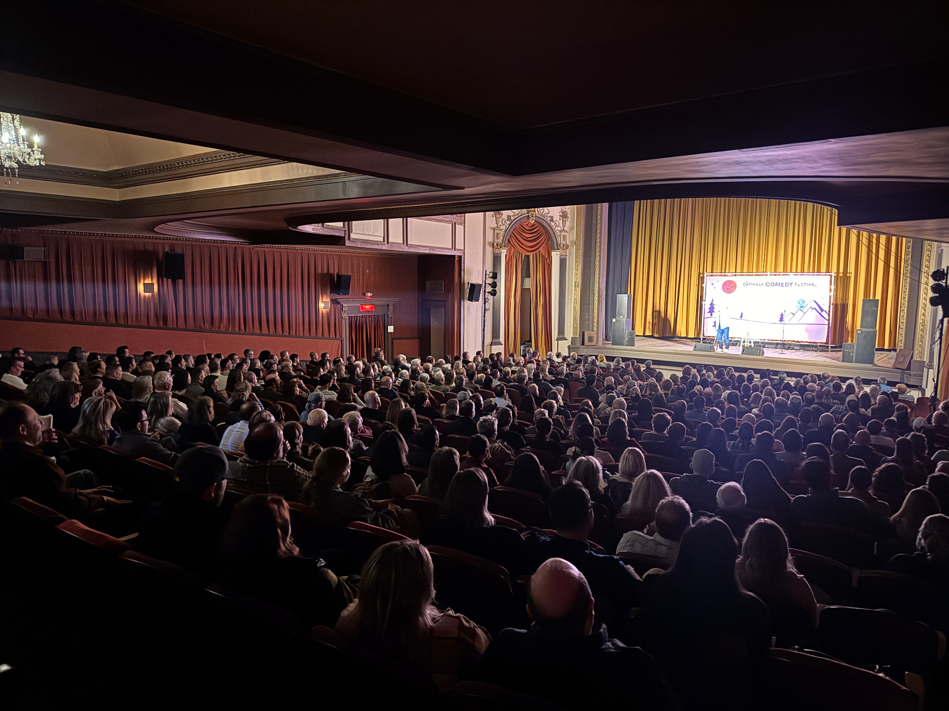 A packed Community Theatre audience watching a festival set